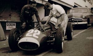 Famed Moss mechanic Alf Francis, author Robinson tend to the engine in Sir StirlingÕs 250F Maserati.Photo: Tony Robinson Collection 