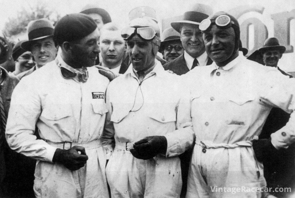 Tazio Nuvolari chats with Eugenio Siena (left) and Baconin Borzacchini (right) during practice for the 1934 Grand Prix of Italy. 