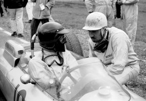  Prior to the 1962 United States Grand Prix at Watkins Glen, Bonnier consults with Porsche teammate Dan Gurney, who would that day be driving his finale race for the Porsche factory team.<br /> Photo: Porsche