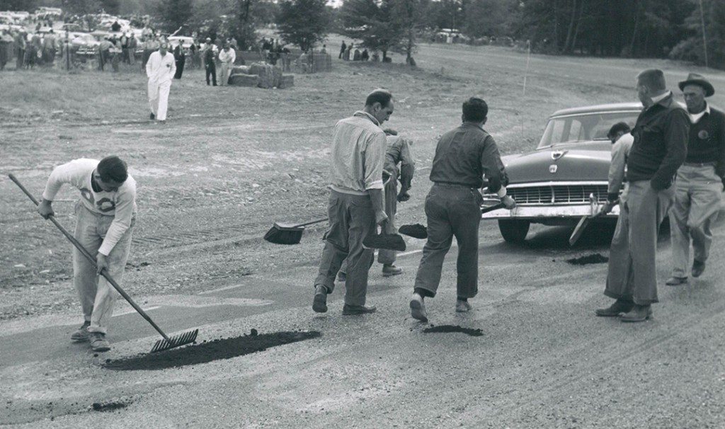 The racing surface didn’t have time to cure properly, so it had to be repaired at intervals by work crews with shovels of asphalt and rakes to smooth it out. A 1956 Ford served as transport for the repair crew.