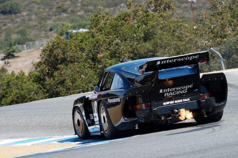 Fred Kaimer's Porsche 935 K3 blows flames as he sets up for the Corkscrew. DennisGray