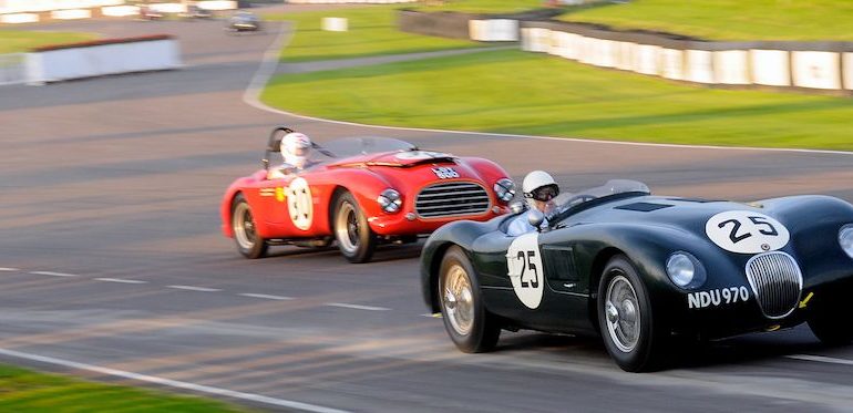 Stirling Moss in the Jaguar C-Type tries to stay clear of the Tojeiro-Bristol