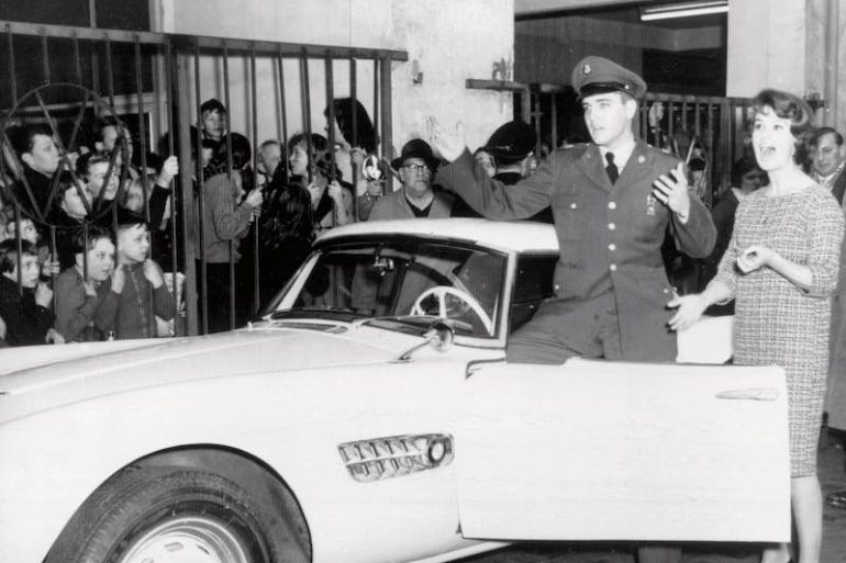 Elvis Presley in front of his BMW 507
