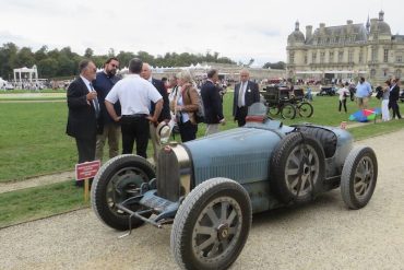 Bugatti Type 35B with the stunning Chateau de Chantilly in the background.