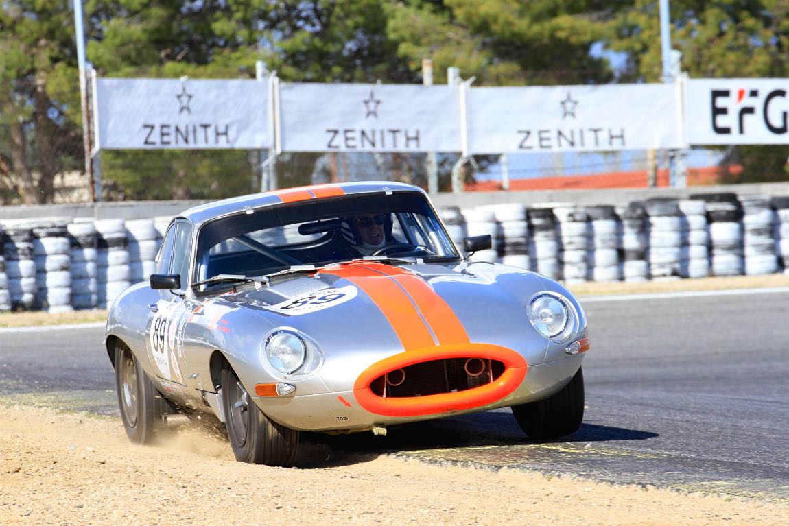 A 1962 Jaguar E-Type Series 1 FHC using every bit of the track
