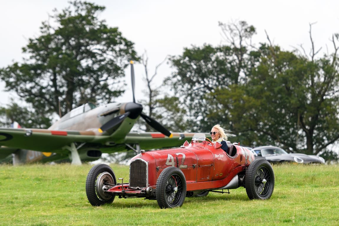 Jennie Taylor in her winning Alfa with her and her late husband's 1940 Hawker Hurricane MKI in the background (Credit TIM SCOTT) TIM SCOTT