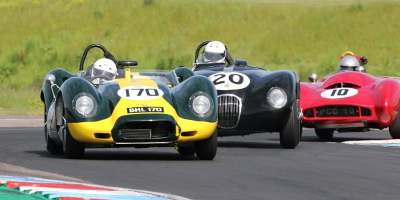 Lister Jaguar, C Type Jaguar and Lotus Mk X scrabble over the kerbs. Picasa