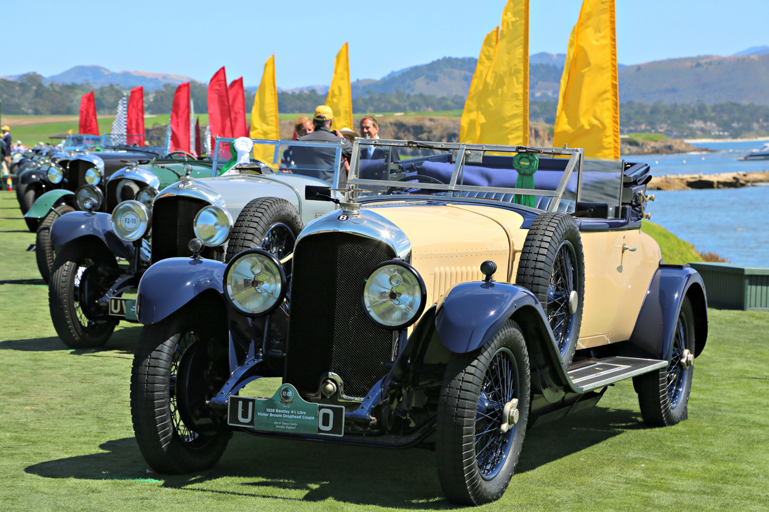 A 1928 Bentley 4 1/4 Litre Victor Broom Crophead Coupe owned by Jim & Tanya Clarke leads an impressive line of Bentley automobiles to celebrate the 100th anniversary of the marque.