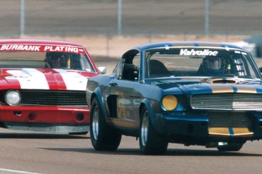 The Shelby GT350 of Jim Click leads the Camaro of Bob Scheer.
