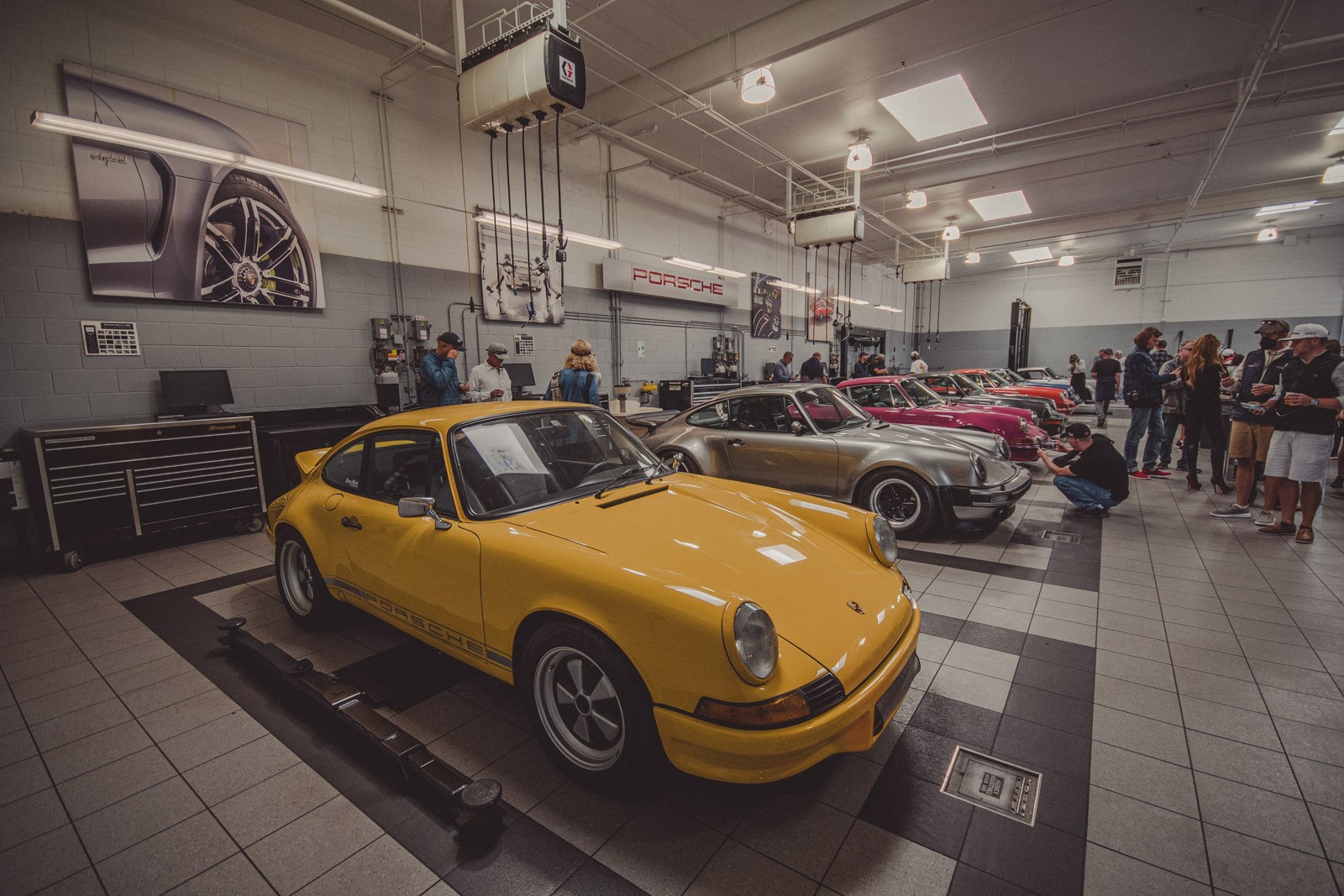 Classic Porsche's on display inside the service bay at Porsche Monterey