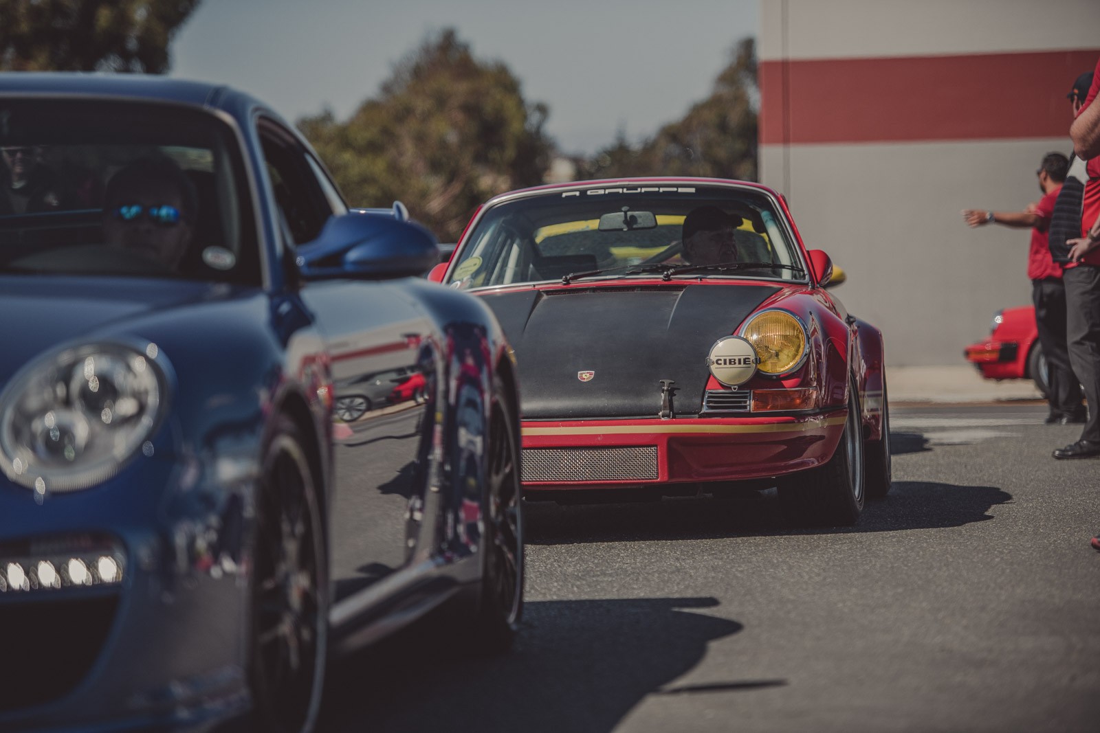 Porsche owners pulling in to park at the Porsche Classic event