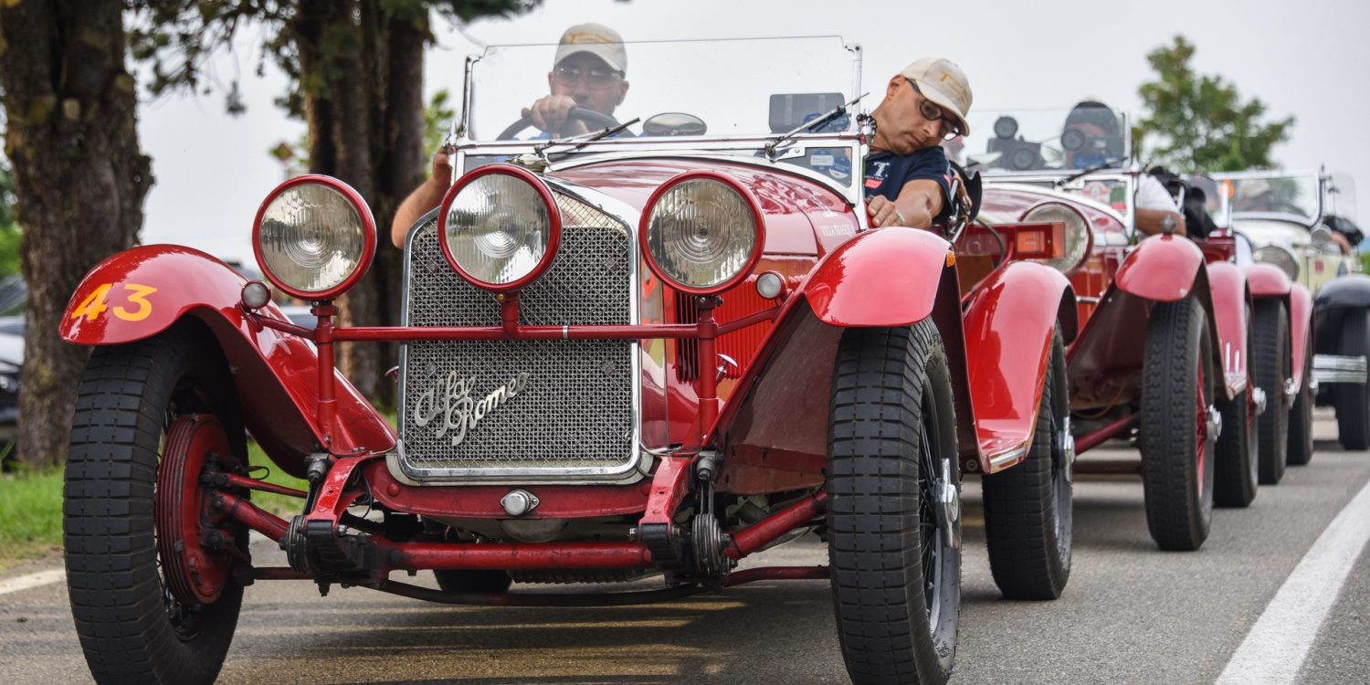 Line of red cars on road during 2021 Mille Miglia