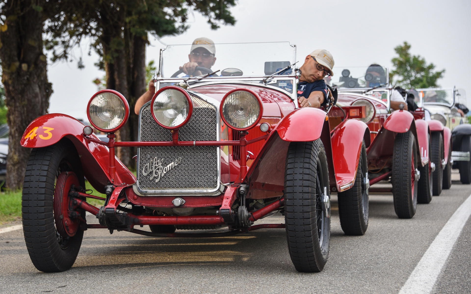 Line of red cars on road during 2021 Mille Miglia