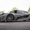 SCG 004 parked on road with trees in background