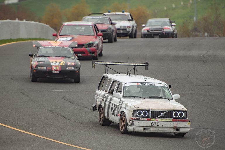#670 1992 Volvo 245 - Team Bernal Dads Racing leads th pack out of Turn 5