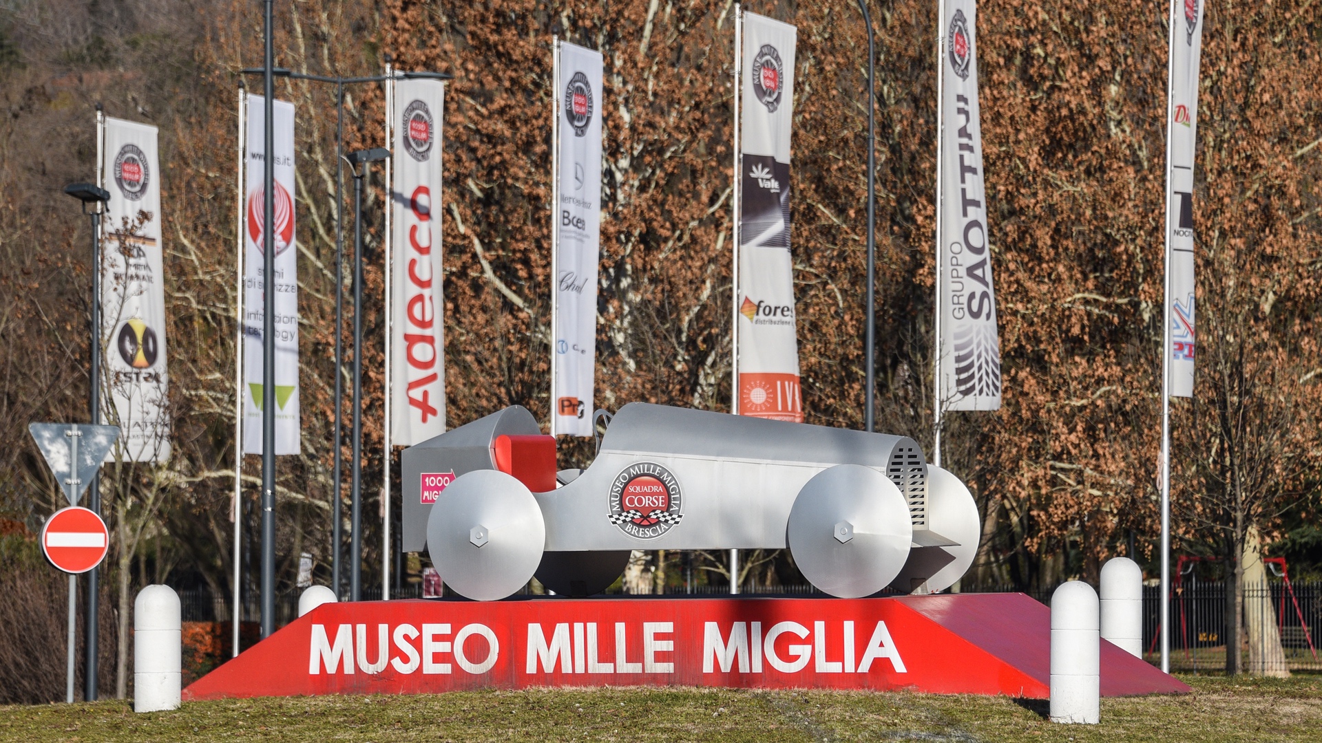 Sign and sculpture outside Mille Miglia Museum