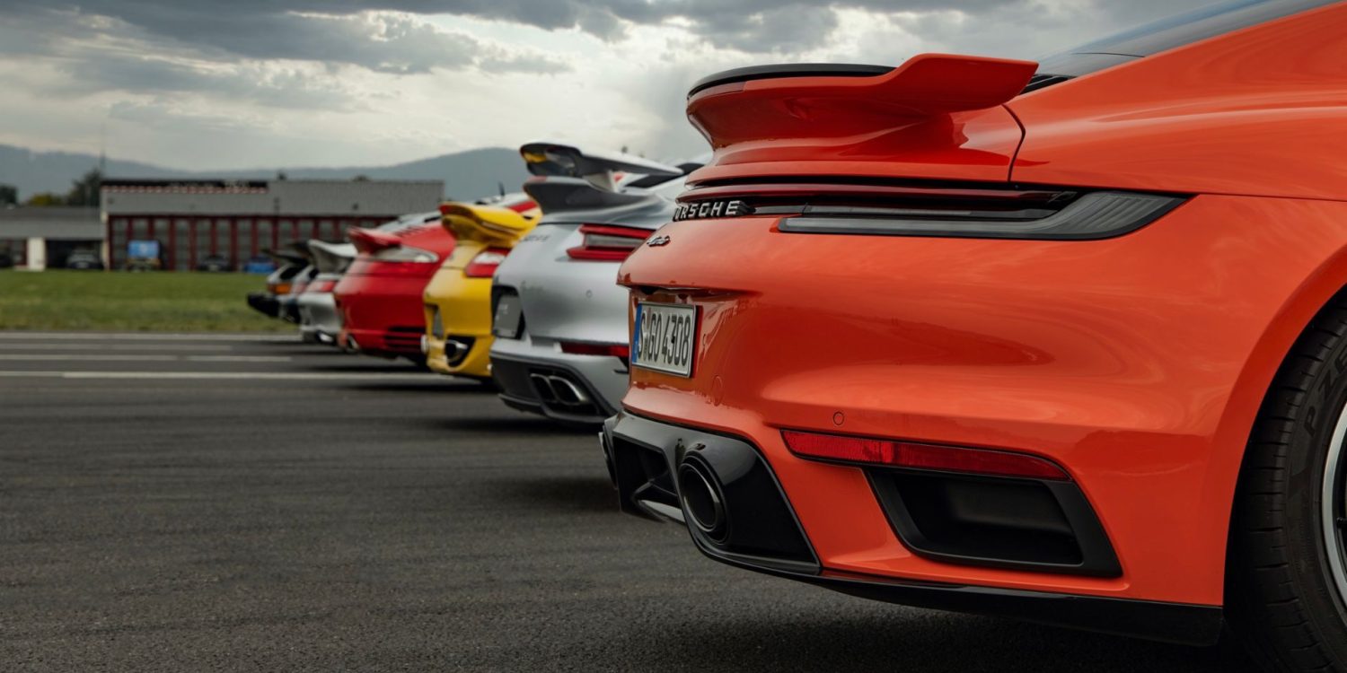 Row of Porsche cars in multiple colors on road