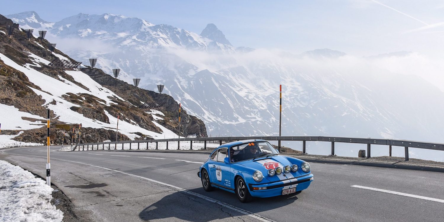 Car on snowy mountain pass during Coppa delle Alpi