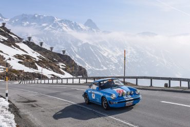 Car on snowy mountain pass during Coppa delle Alpi