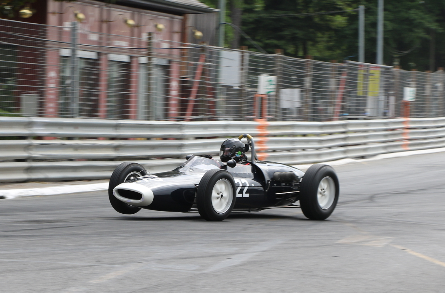 PETER HORSMAN LIFTS A FRONT WHEEL OF HIS LOTUS18-21 INTO STATION HAIRPIN. Picasa
