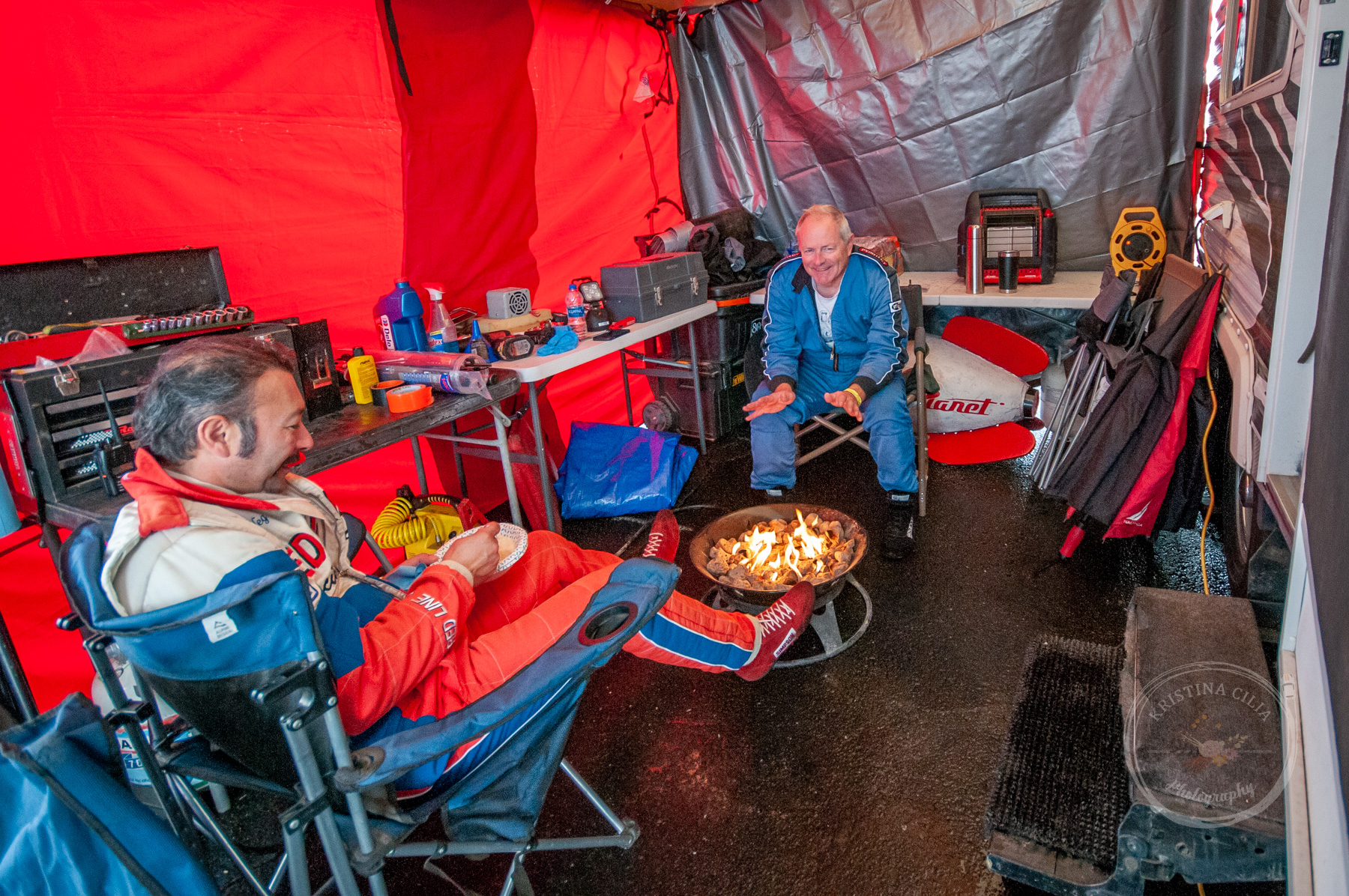 Pizza Planet Truck Racing Team keeps warm while taking a break in the Paddock Kristina Cilia