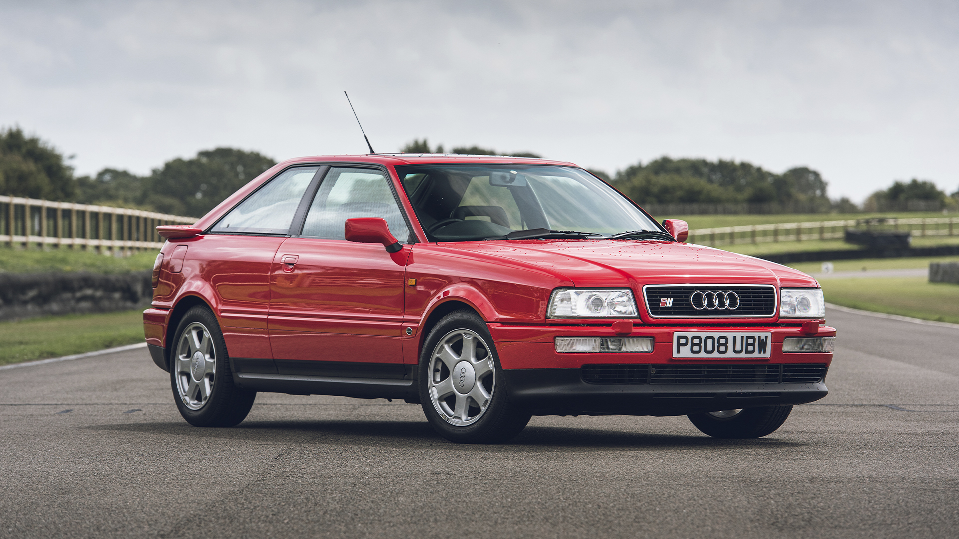 Photo of a red Audi S2 on a racetrack