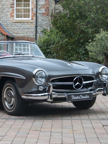 1958 silver Mercedes Benz 190 SL on a city street