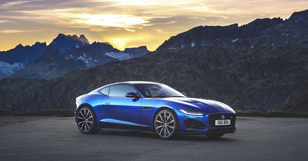 Photo of a blue Jaguar F-Type R with mountain background