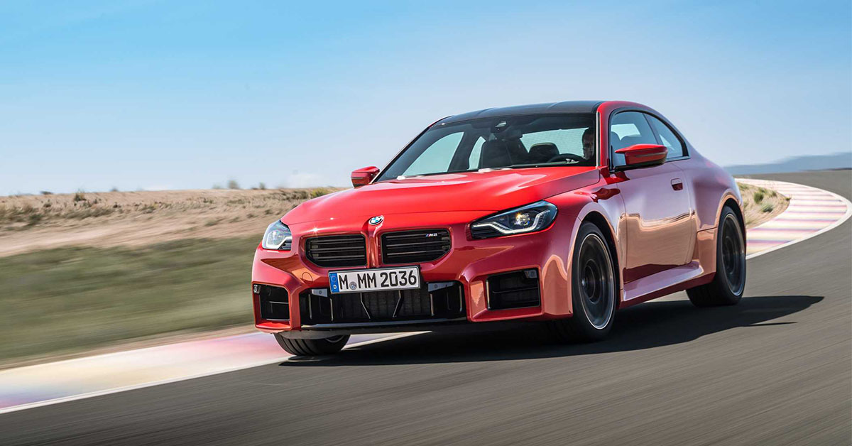 Photo of a red BMW M2 at a race track