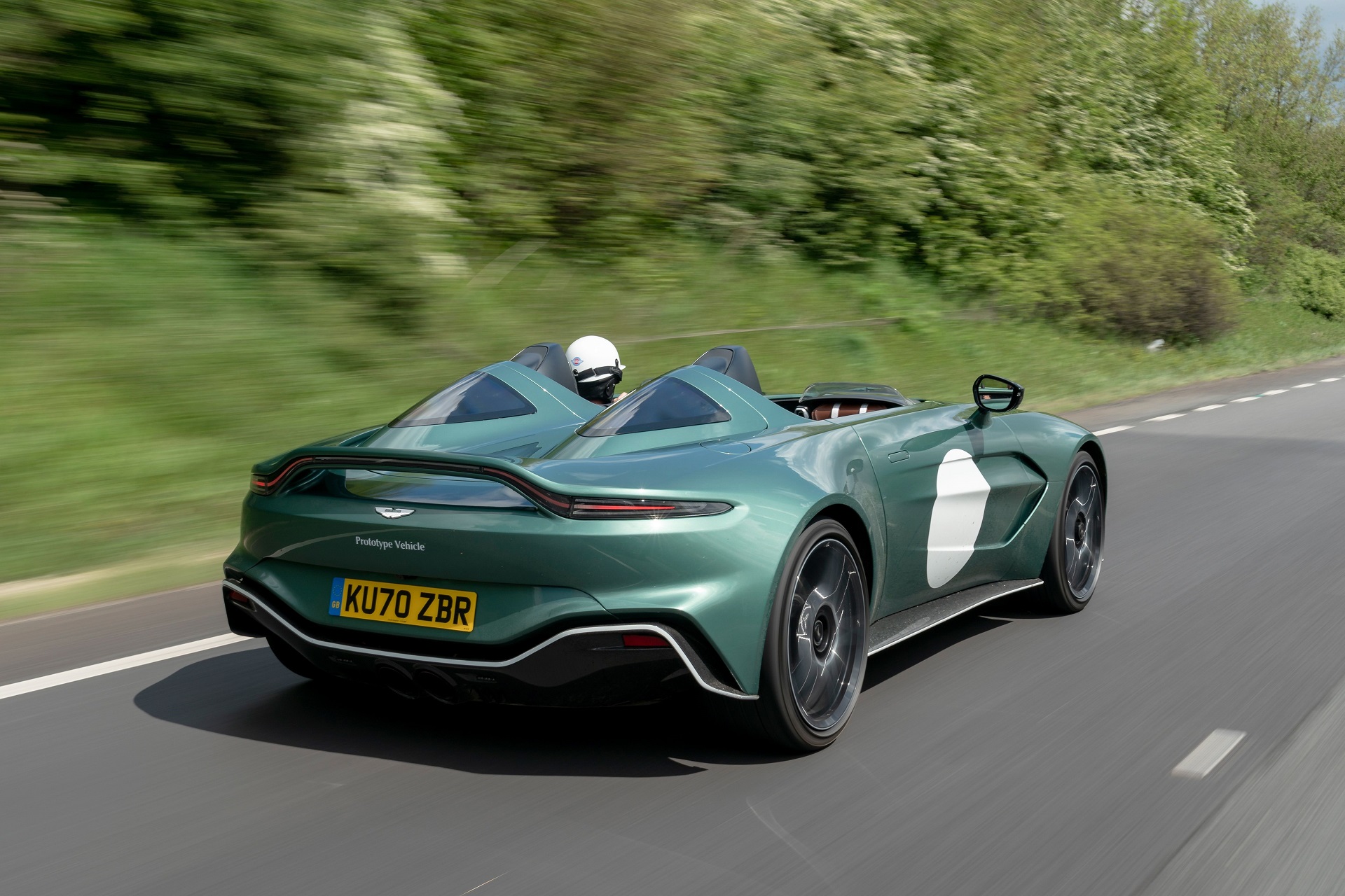  Rear-angled view of a green Aston Martin V12 Speedster.