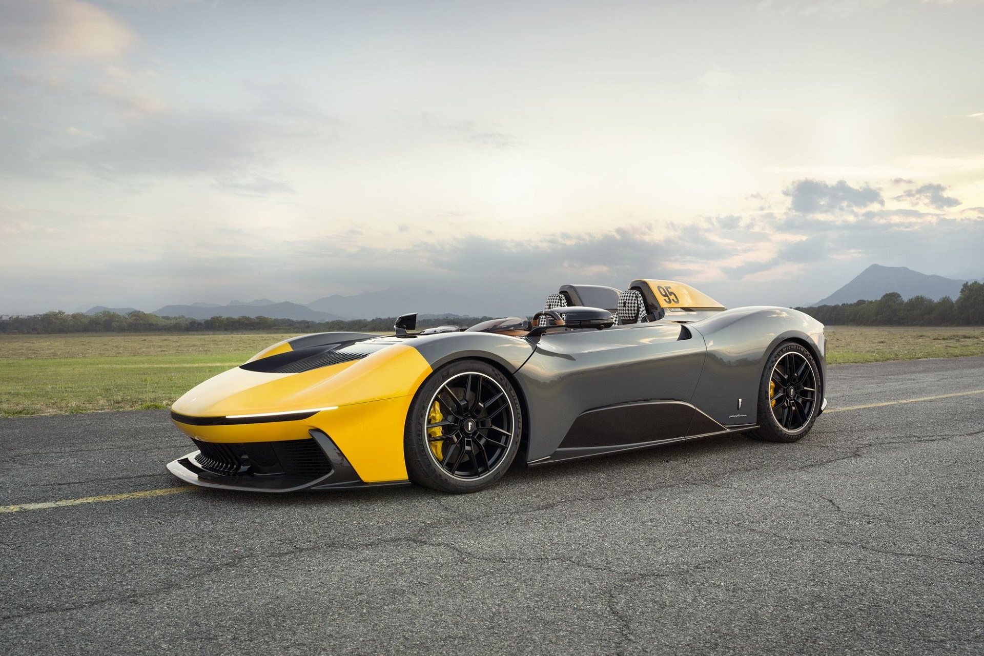  front angled view of the Pininfarina B95 electric speedster, finished in yellow and grey.
