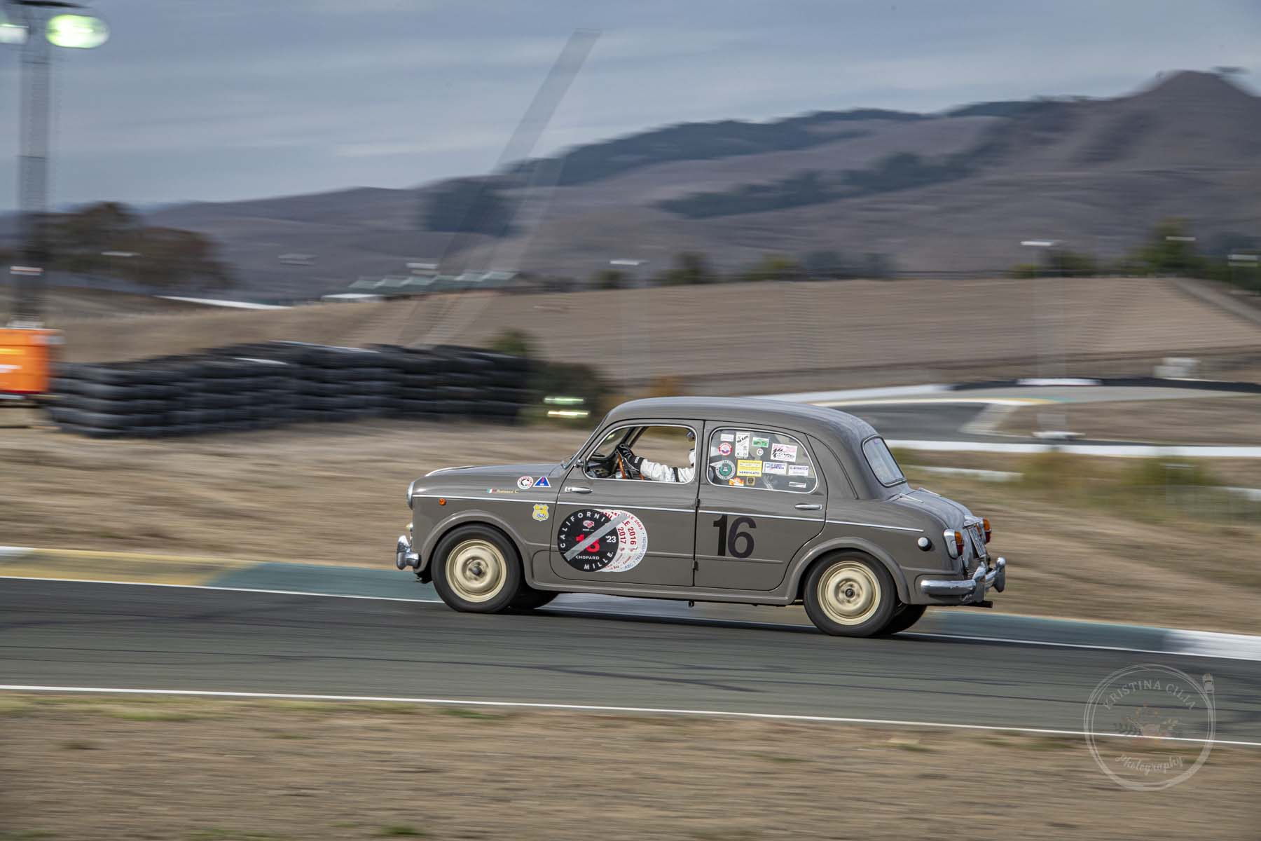 A 1953 Fiat 1100/103 zips up the hill into Turn 2