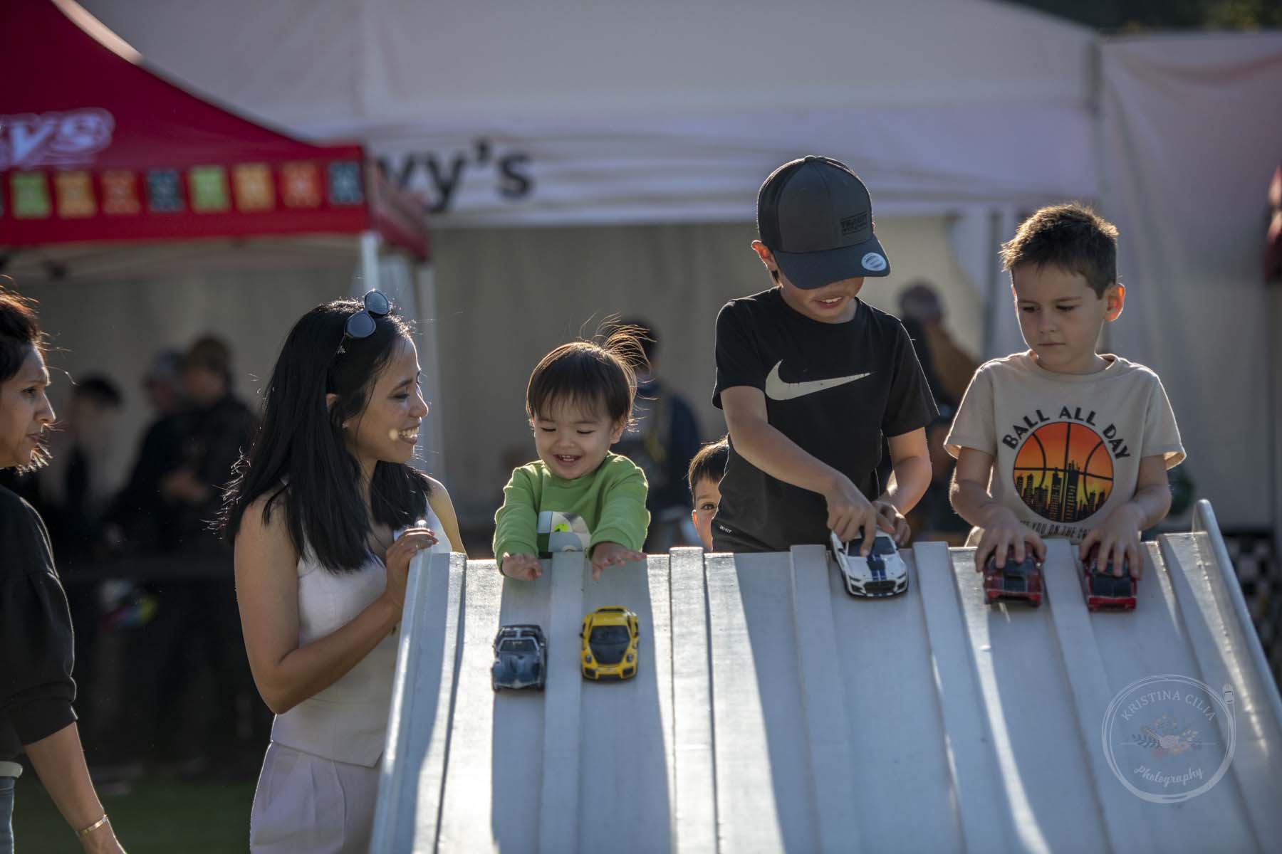 Kids enjoy playing with the toy racecars during Velocity Invitational 2023 at Sonoma Raceway