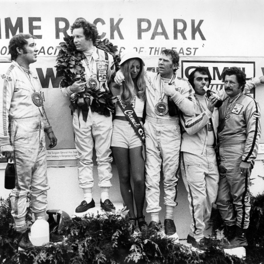 The winning 1973 Lime Rock Camel GT class drivers on the podium. L to R, Warren Agor, Peter Gregg, Ludwig Heimrath Jr. Dave Nichols and John Magee. Fast company indeed!