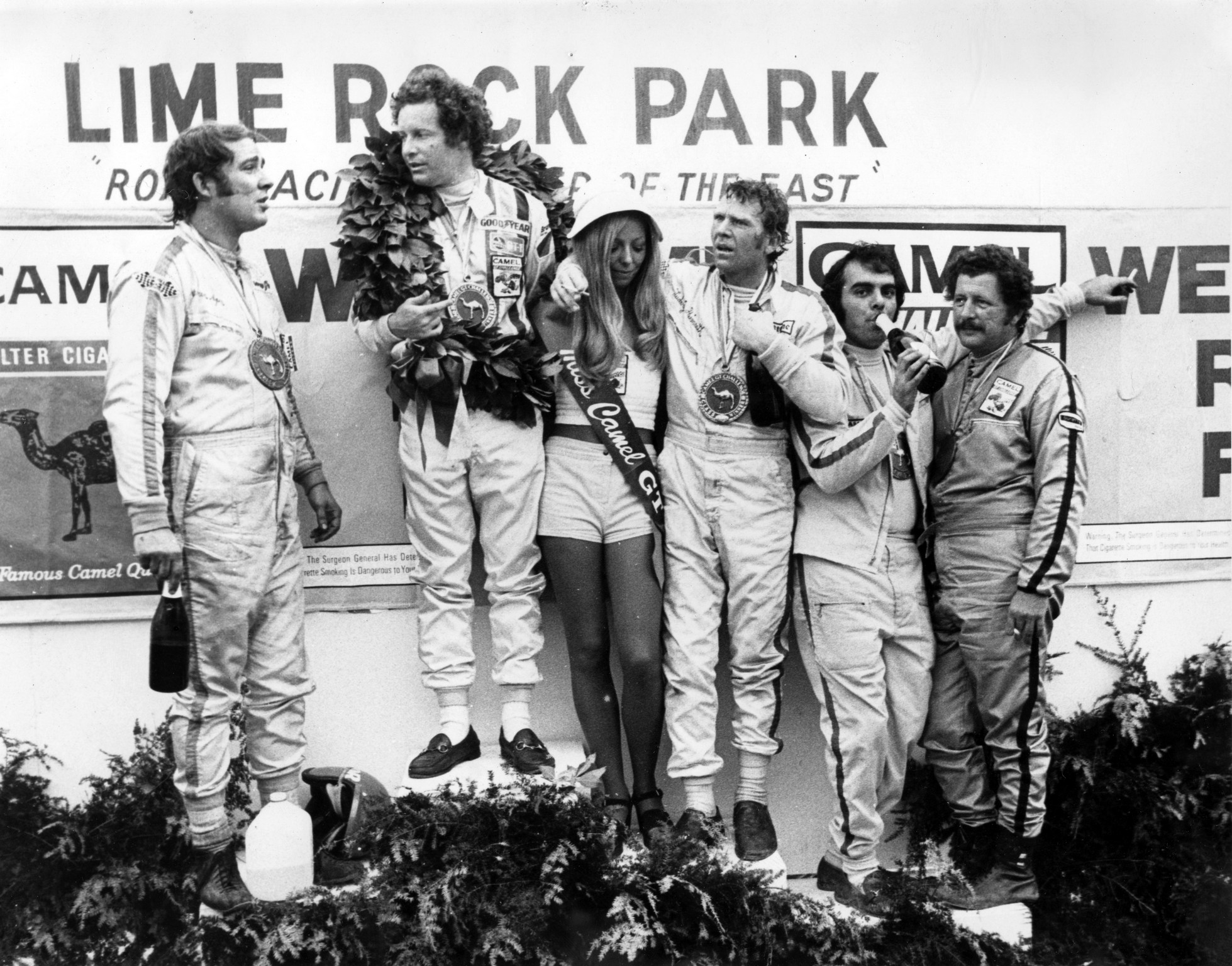 The winning 1973 Lime Rock Camel GT class drivers on the podium. L to R, Warren Agor, Peter Gregg, Ludwig Heimrath Jr. Dave Nichols and John Magee. Fast company indeed!