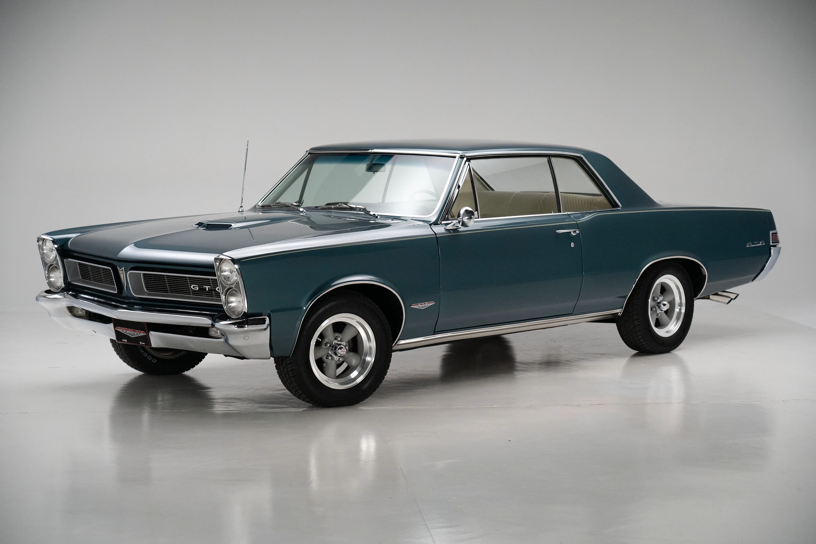  Three-quarter side view of a restored 1965 turquoise Pontic GTO