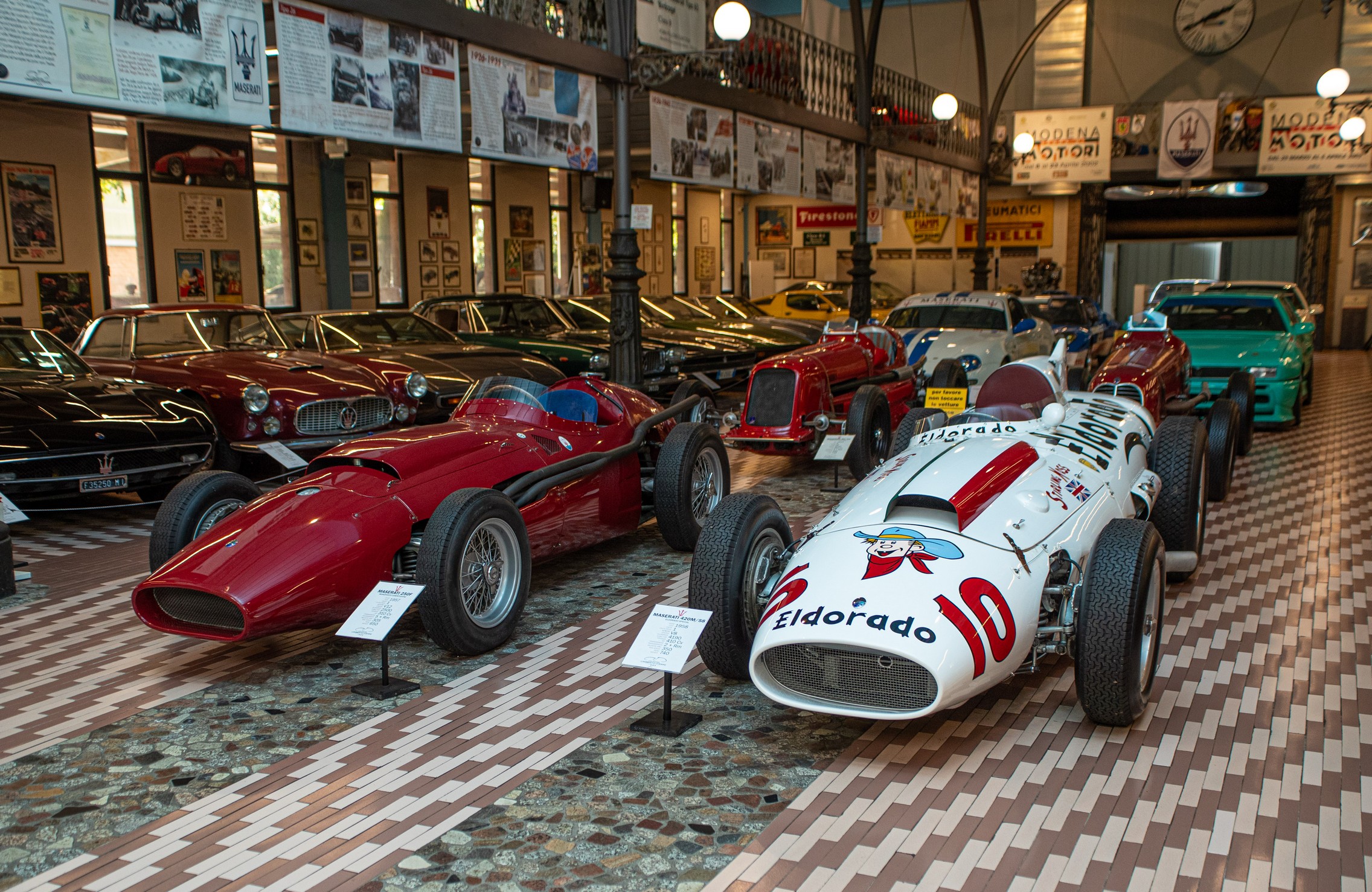 Greeting visitors to the Umberto Panini Motor Museum Collection, are: (left) 1957 Maserati 250 F - 2,500 cc V12 engine; and (right) 1958 Maserati 420M ‘Eldorado Special’ - 4,190 cc V8 engine. © Glen Smale