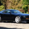 Three-quarter side view of a 1995 black Aston Martin Vantage V550