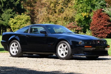 Three-quarter side view of a 1995 black Aston Martin Vantage V550