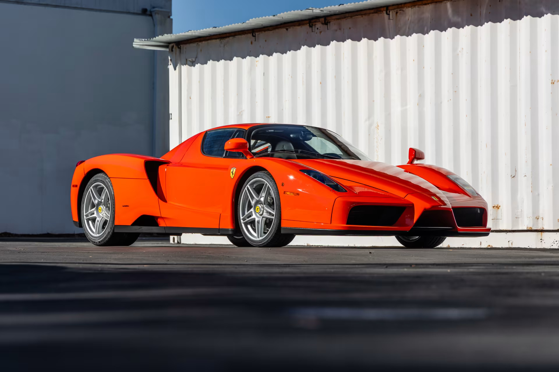 Three-quarter side view of a 2003 Ferrari Enzo finished in Rosso Dino