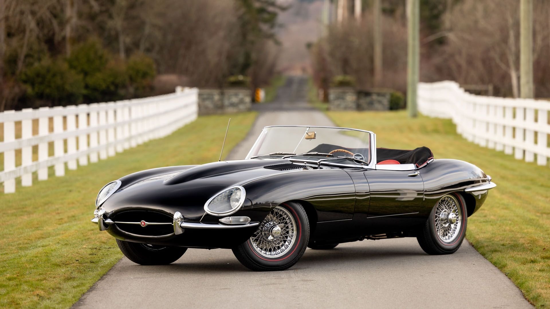 Three-quarter view of a 1962 black Jaguar E-Type Series Roadster