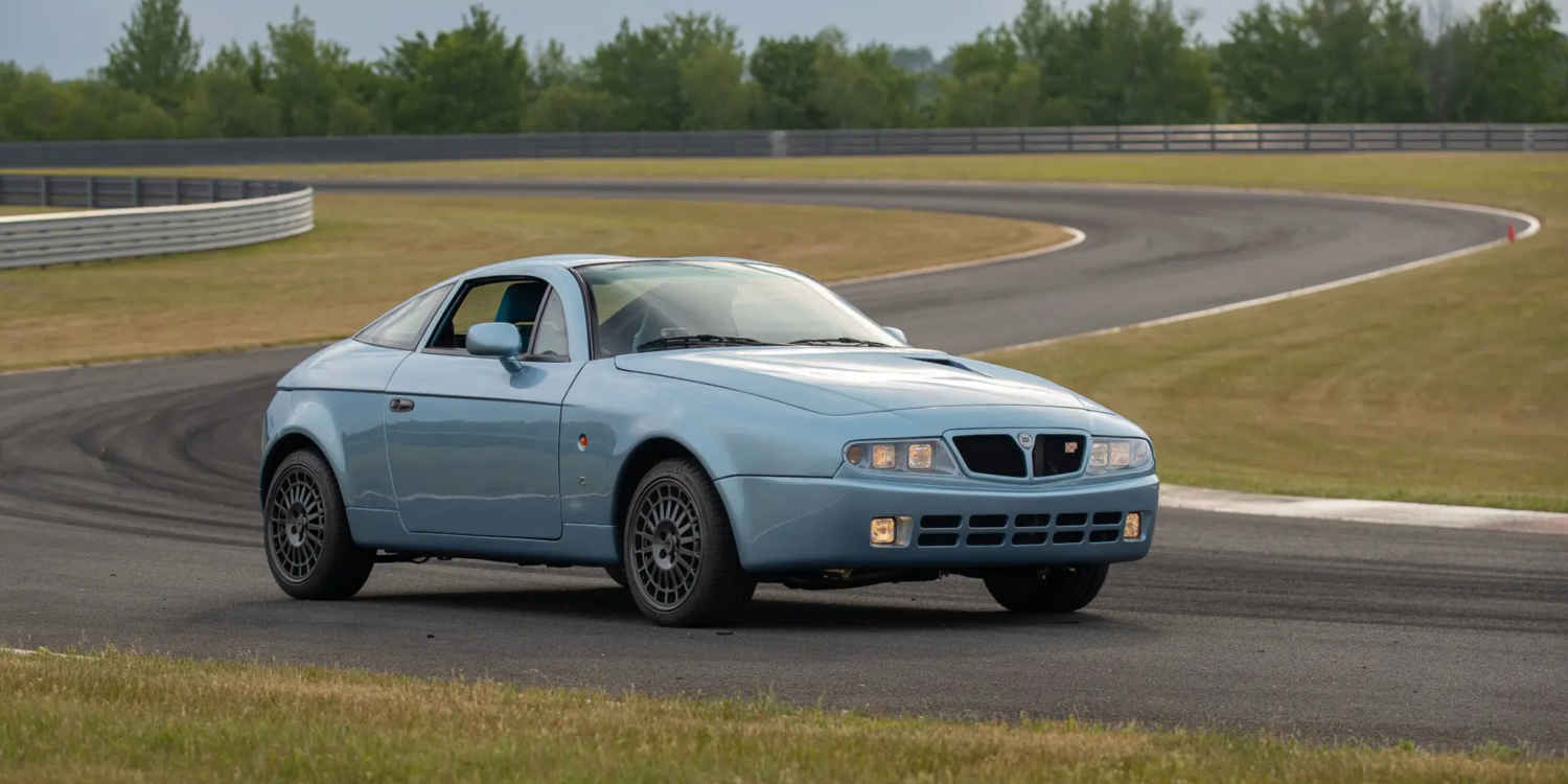 Three-quarter front view of a blue Lancia Hyena by Zagato at a racetrack