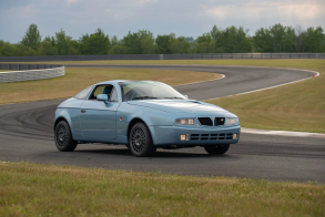 Three-quarter front view of a blue Lancia Hyena by Zagato at a racetrack
