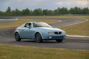 Three-quarter front view of a blue Lancia Hyena by Zagato at a racetrack